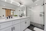 His and her sinks with massive walk-in shower 
